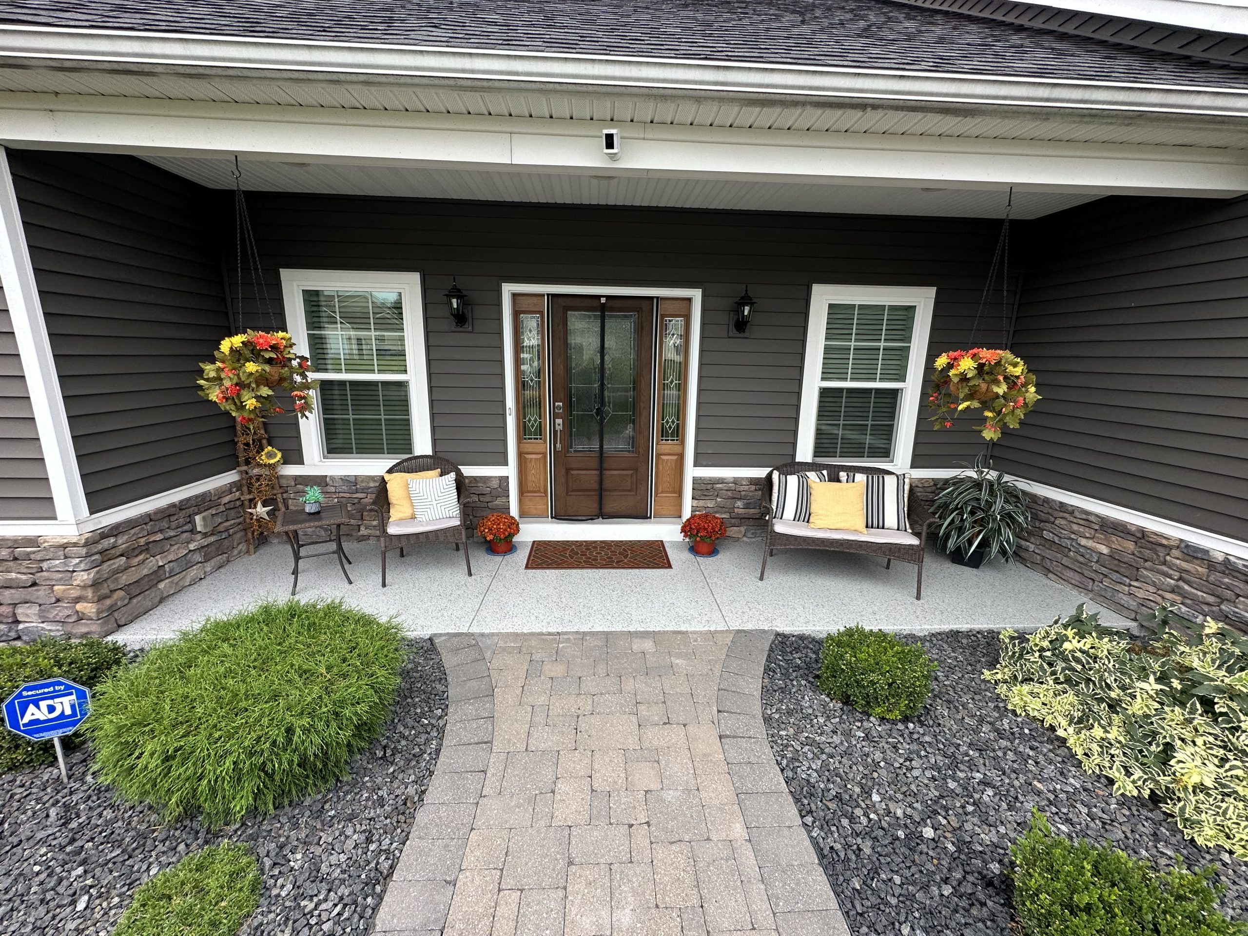 Premium flake floor on a covered porch with chairs and flowers